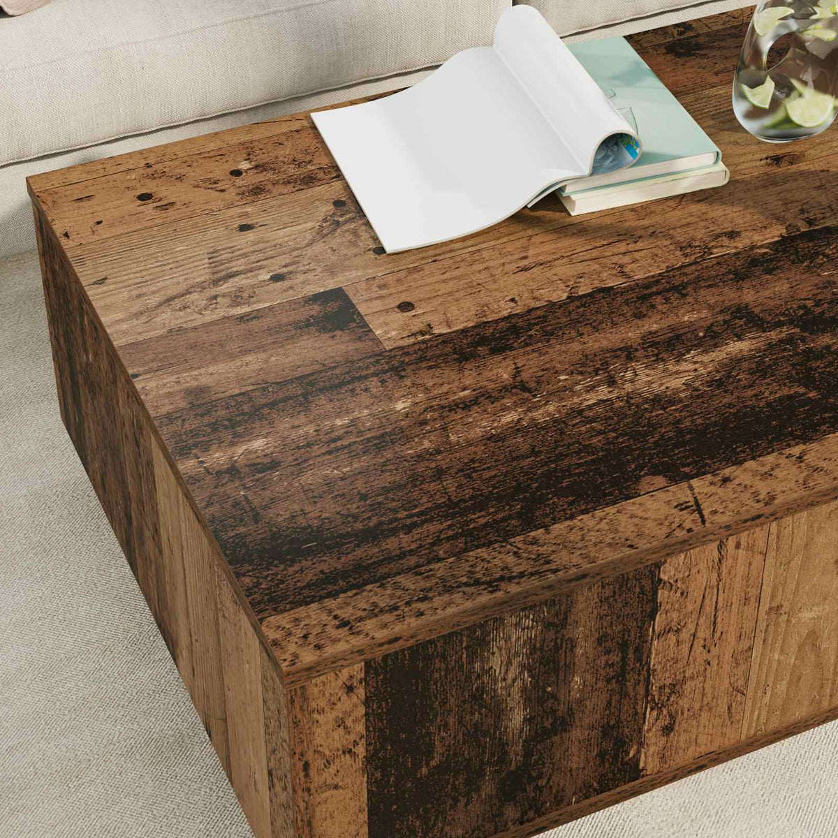A close-up of the coffee table surface showing the dark wood grain texture and an open book