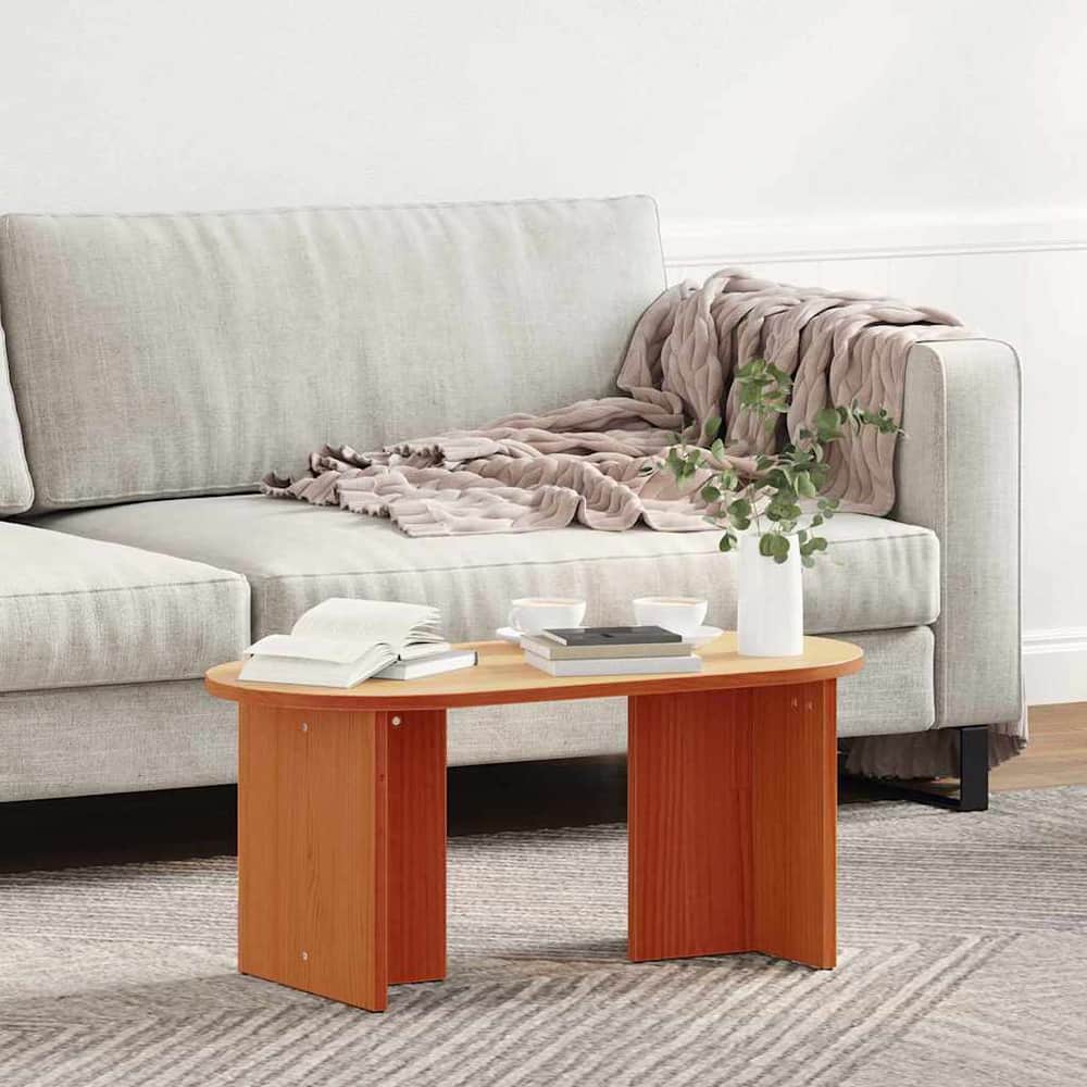 coffee table with a blanket draped over the sofa next to it