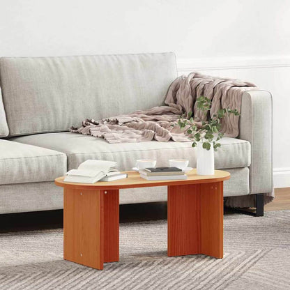 coffee table with a blanket draped over the sofa next to it
