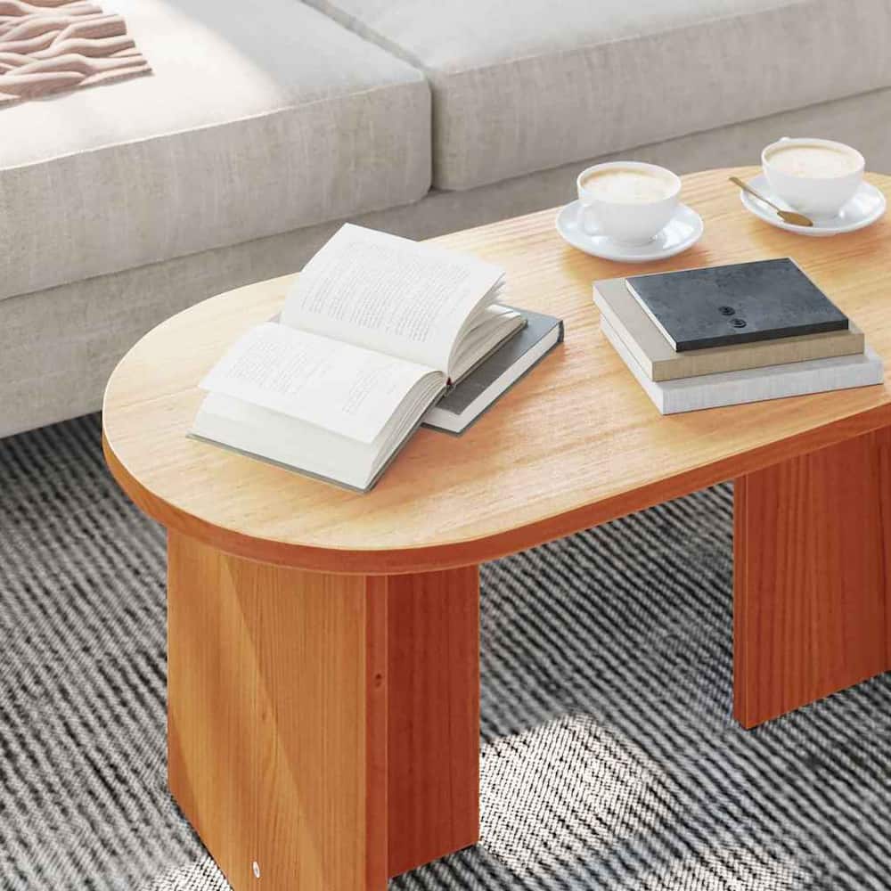 close up of the oval coffee table top with books and cups