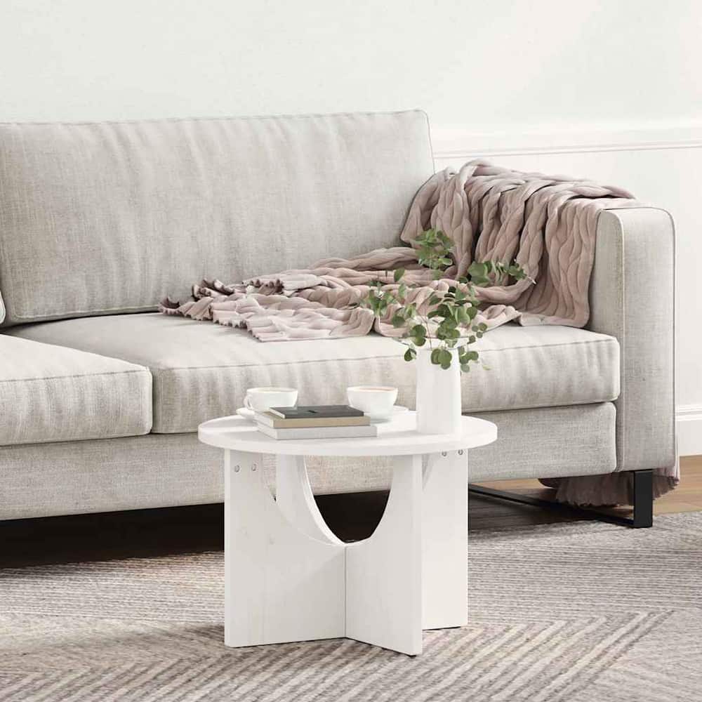 White coffee table placed beside a sofa with a throw blanket draped over it