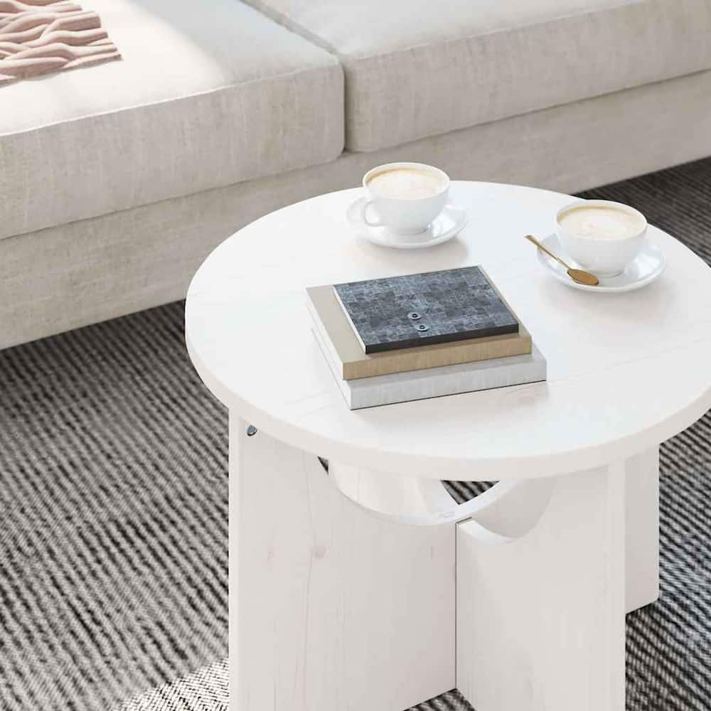Close-up of the white coffee table surface with books and cups