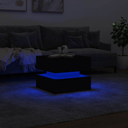Black coffee table with blue LED lights illuminating a dark room