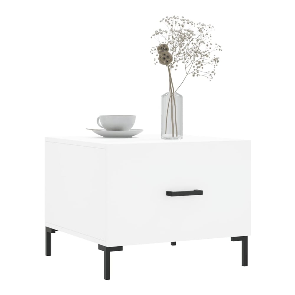 A single white engineered wood coffee table with a drawer and black handle, topped with a vase and cup