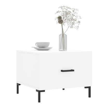 A single white engineered wood coffee table with a drawer and black handle, topped with a vase and cup