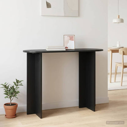 A black console table in a room setting with a plant and artwork on the wall