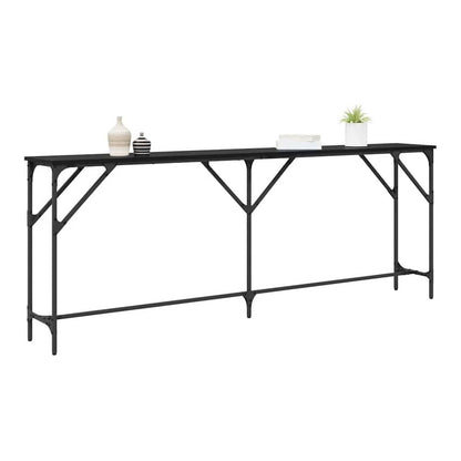 The black oak console table displayed with decorative items on top