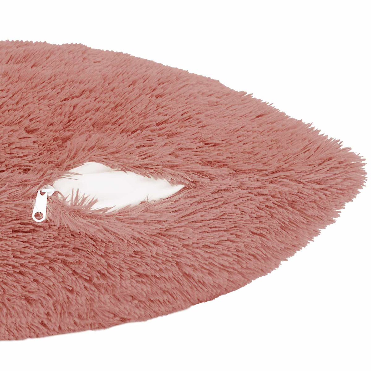 the corner of the pink cushion cover showing the zip fastener