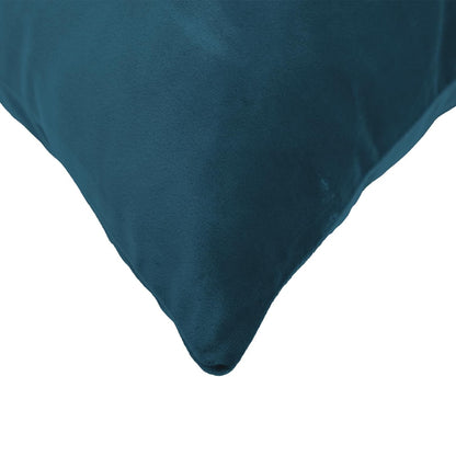 Close up of the corner of a blue velvet cushion, showing texture