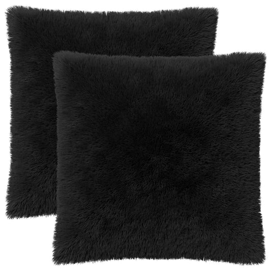 Two black fluffy throw pillows, one slightly behind the other