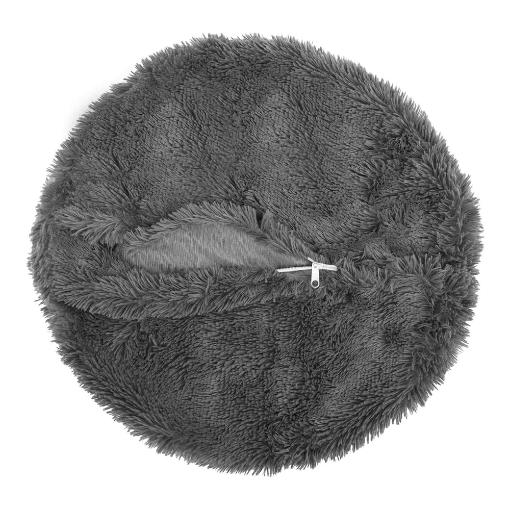 A grey round throw pillow with an open zip