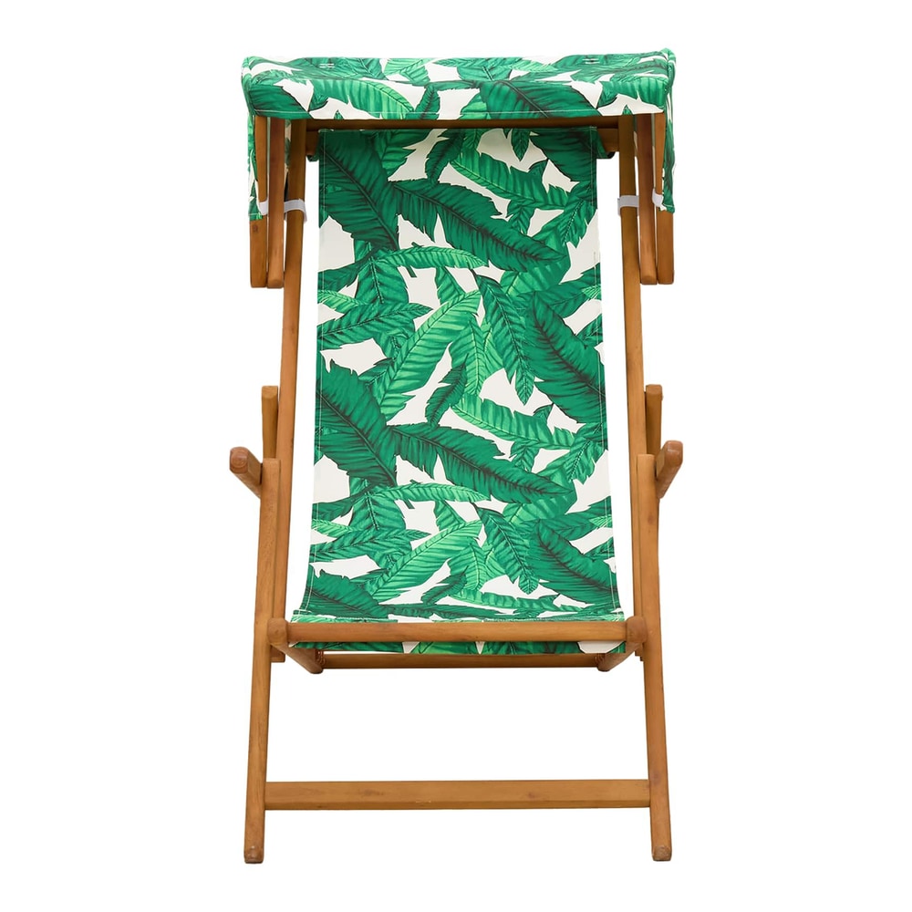 Front view of the wooden deck chair with a green leaf pattern fabric and canopy