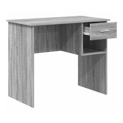 The grey engineered wood desk with the drawer pulled out, revealing the storage space inside