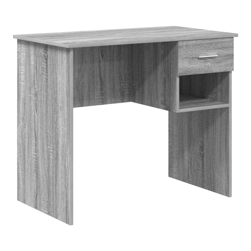 The grey engineered wood desk is shown from the front, highlighting its simple design and storage cubby