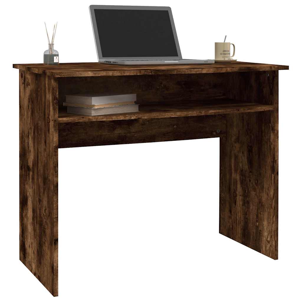 The desk styled with a laptop and accessories on the work surface and shelf
