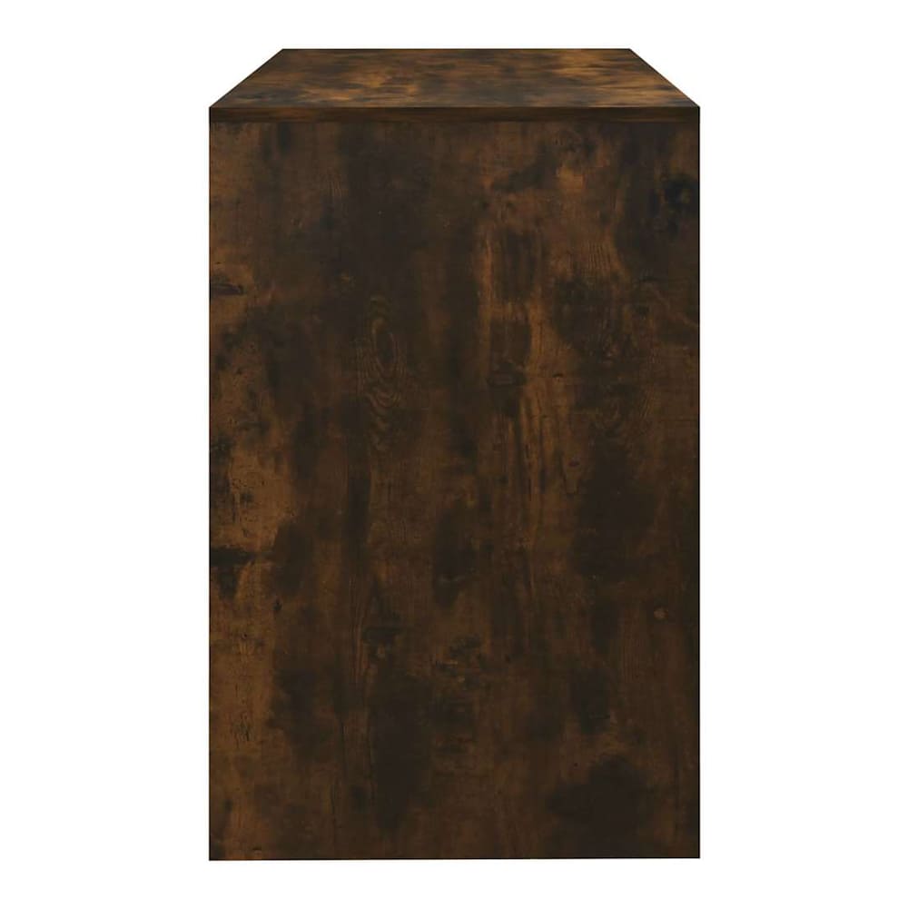 Side view of the smoked oak engineered wood desk showing its depth
