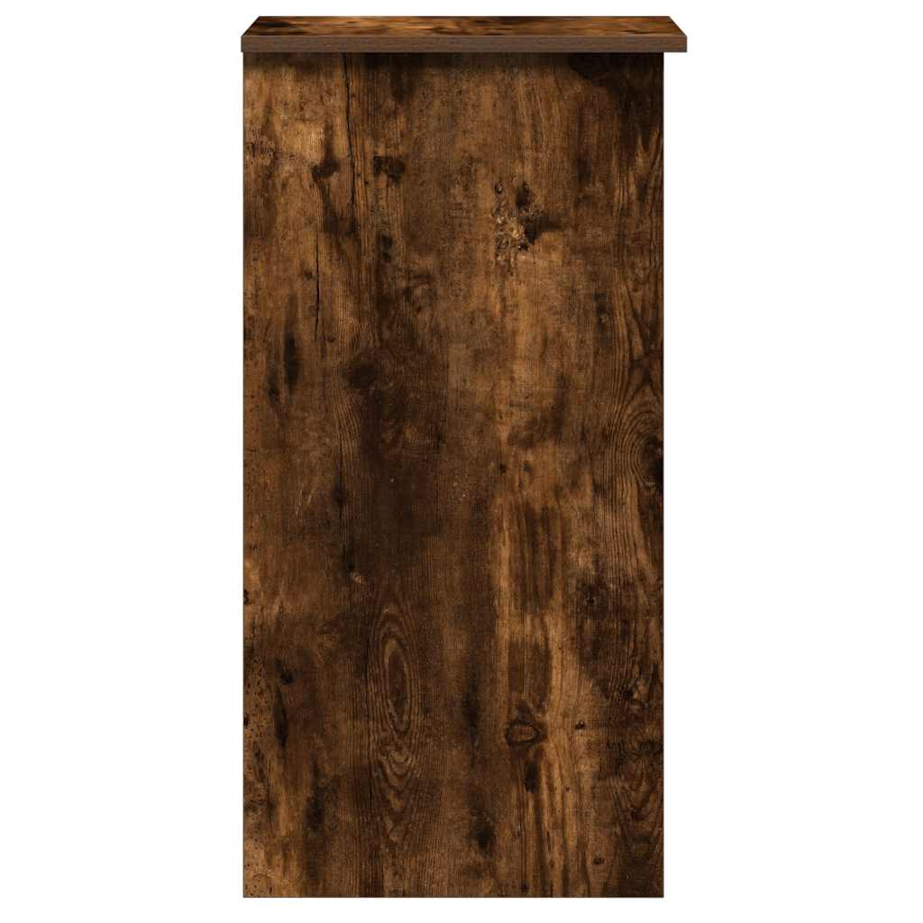 The side of the smoked oak engineered wood desk showing the wood grain texture