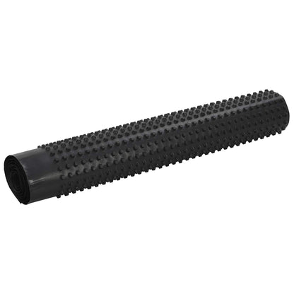 Rolled black dimpled drainage sheet on a white background