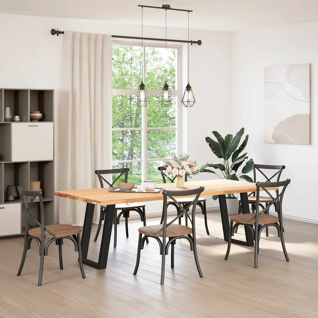 Two black U-shaped table legs fitted to a wooden dining table in a room