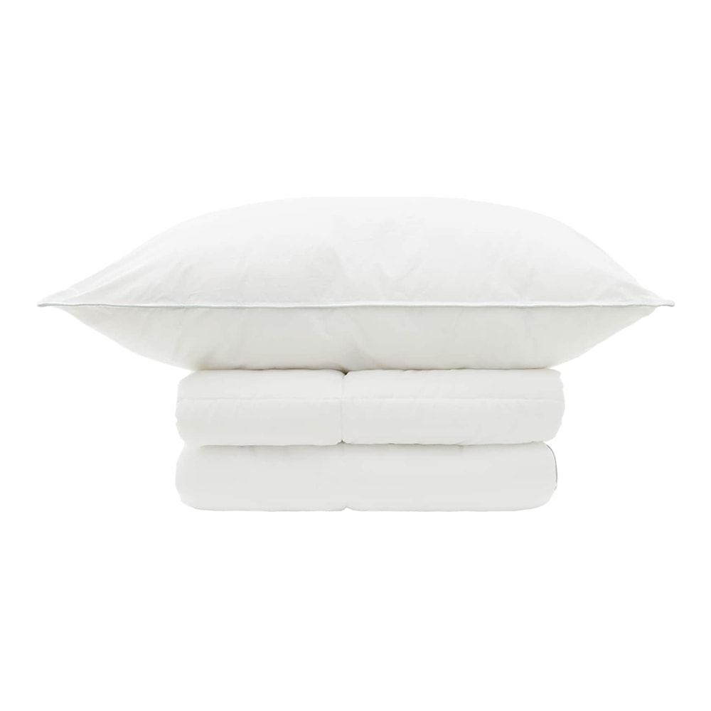 The white pillow placed horizontally on top of the neatly folded white duvet