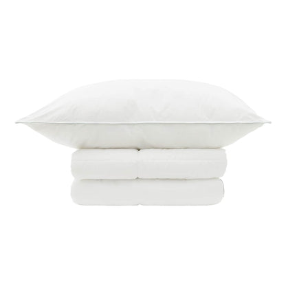The white pillow placed horizontally on top of the neatly folded white duvet