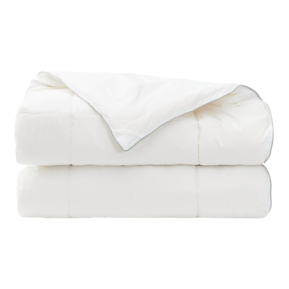 The wool duvet is stacked in two layers with the top corner folded over the front