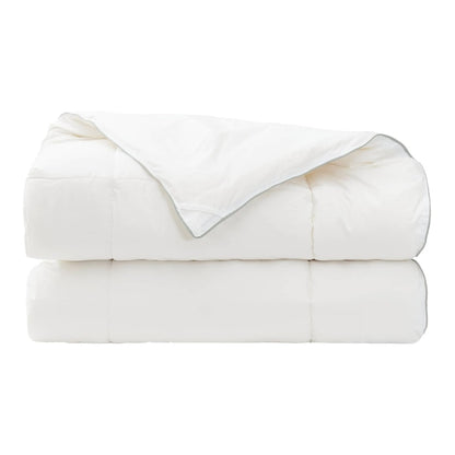 The wool duvet is stacked in two layers with the top corner folded over the front
