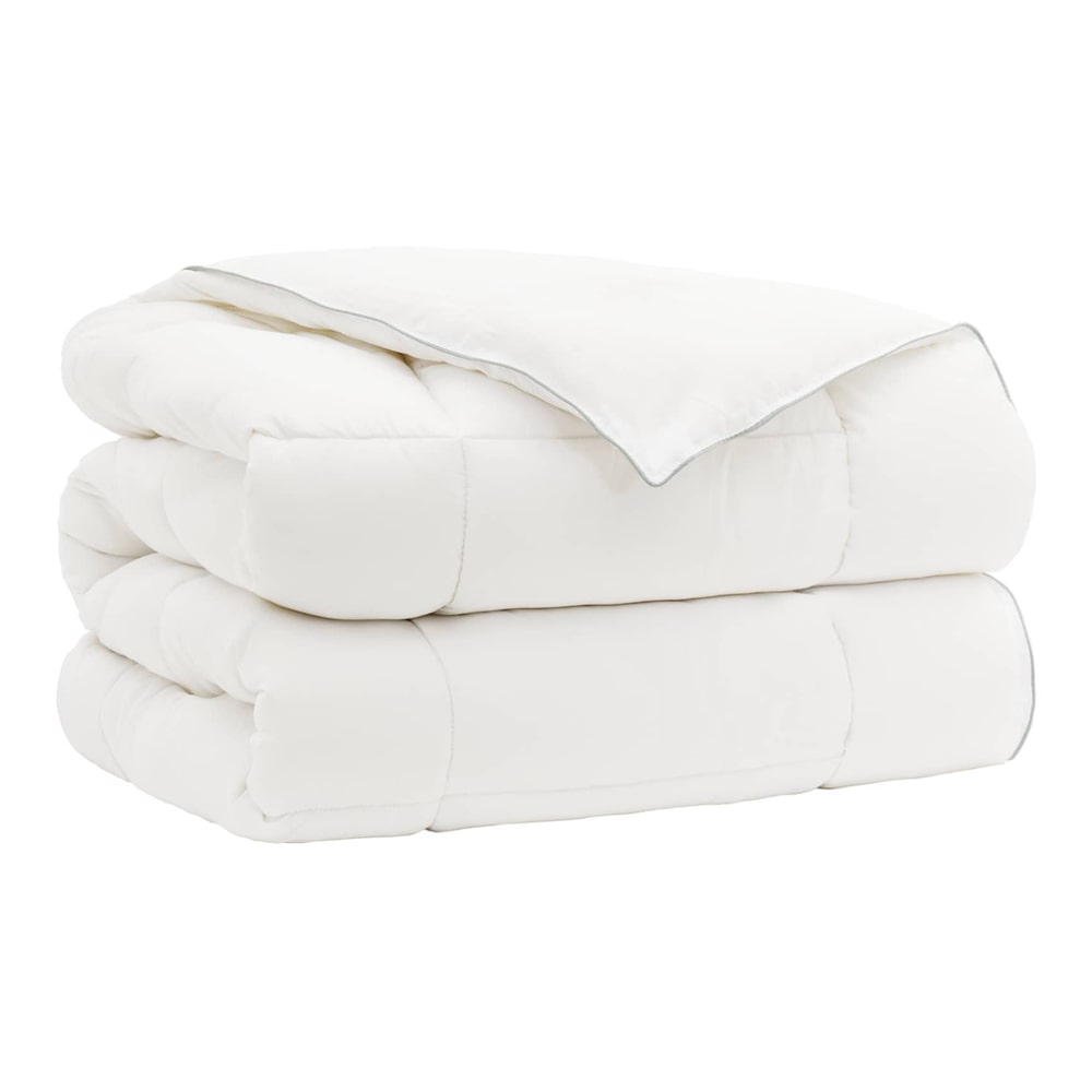 The wool duvet folded into a neat pile with visible stitched edges