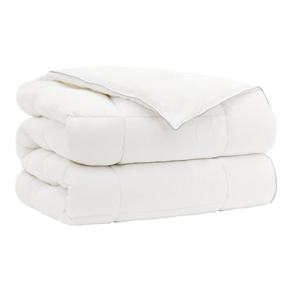 The wool duvet folded into a neat pile with visible stitched edges