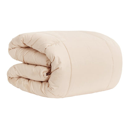 A beige winter duvet folded in half, showing its soft quilted texture