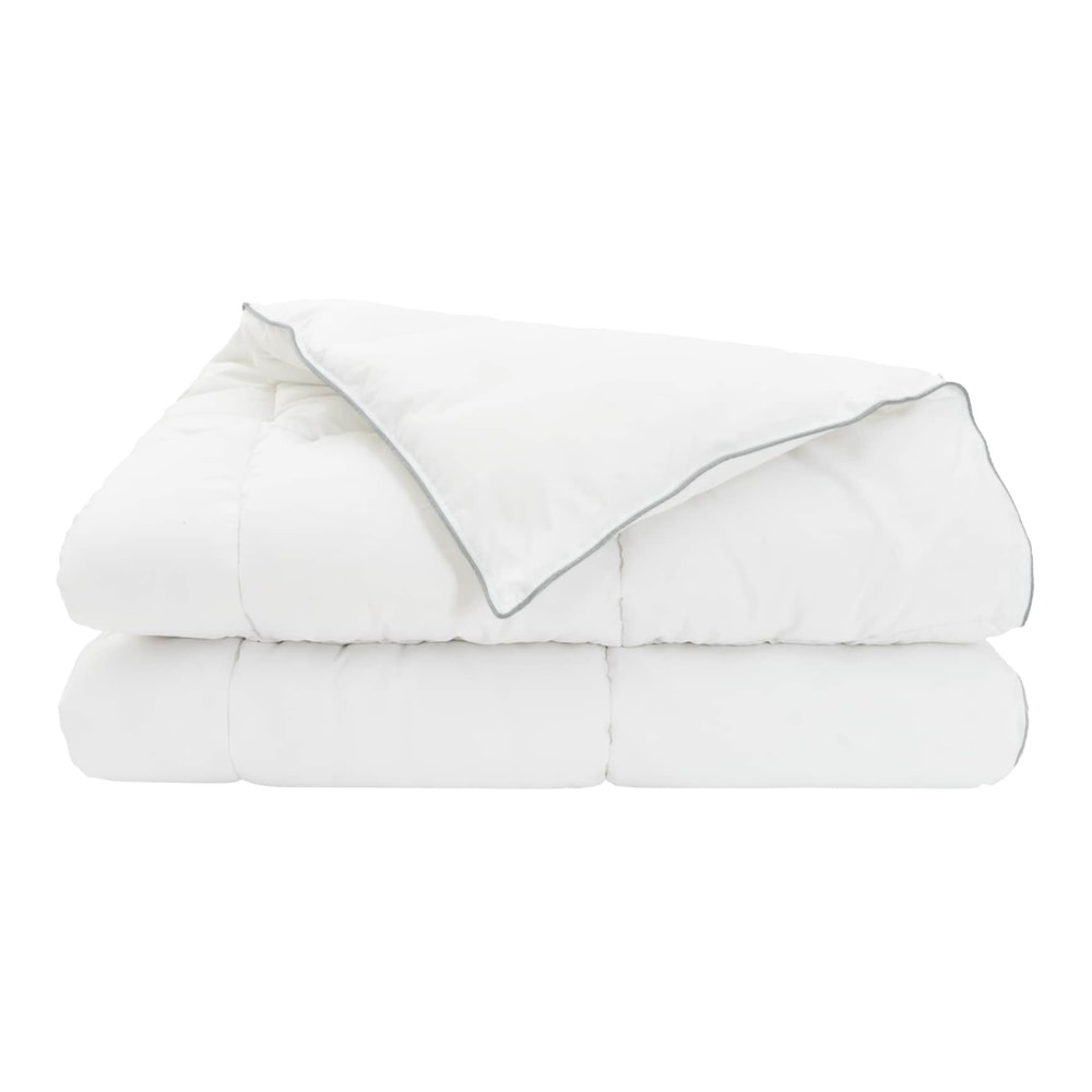 the white duvet and pillow set stacked neatly with one corner folded over