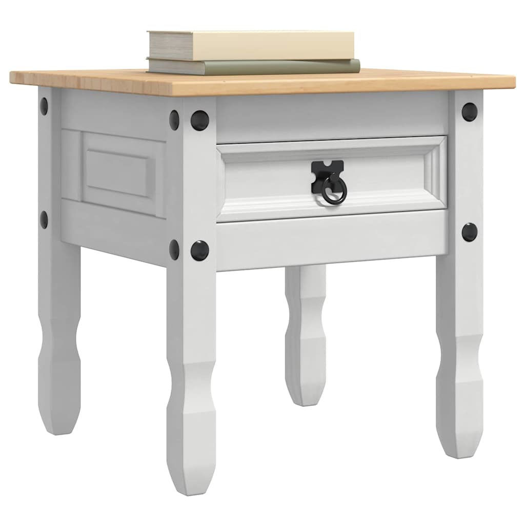 The white end table with a wooden top and a drawer, holding books
