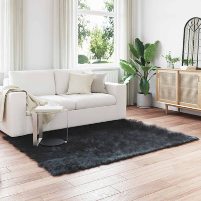 vidaXL Faux Sheepskin Rug TAFALLA Black laid out on a wooden floor in a living room setting