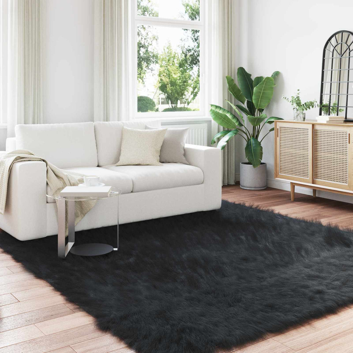 vidaXL Faux Sheepskin Rug TAFALLA Black, a fluffy black rug on a wooden floor in a living room