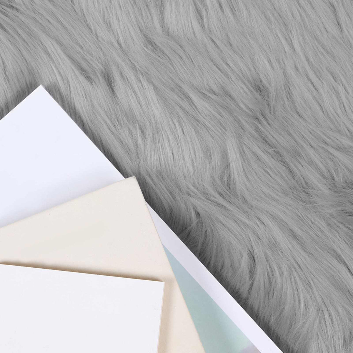 Close up of the soft grey faux sheepskin rug texture
