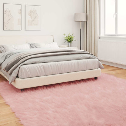 The pink faux sheepskin rug in a bedroom setting with a bed