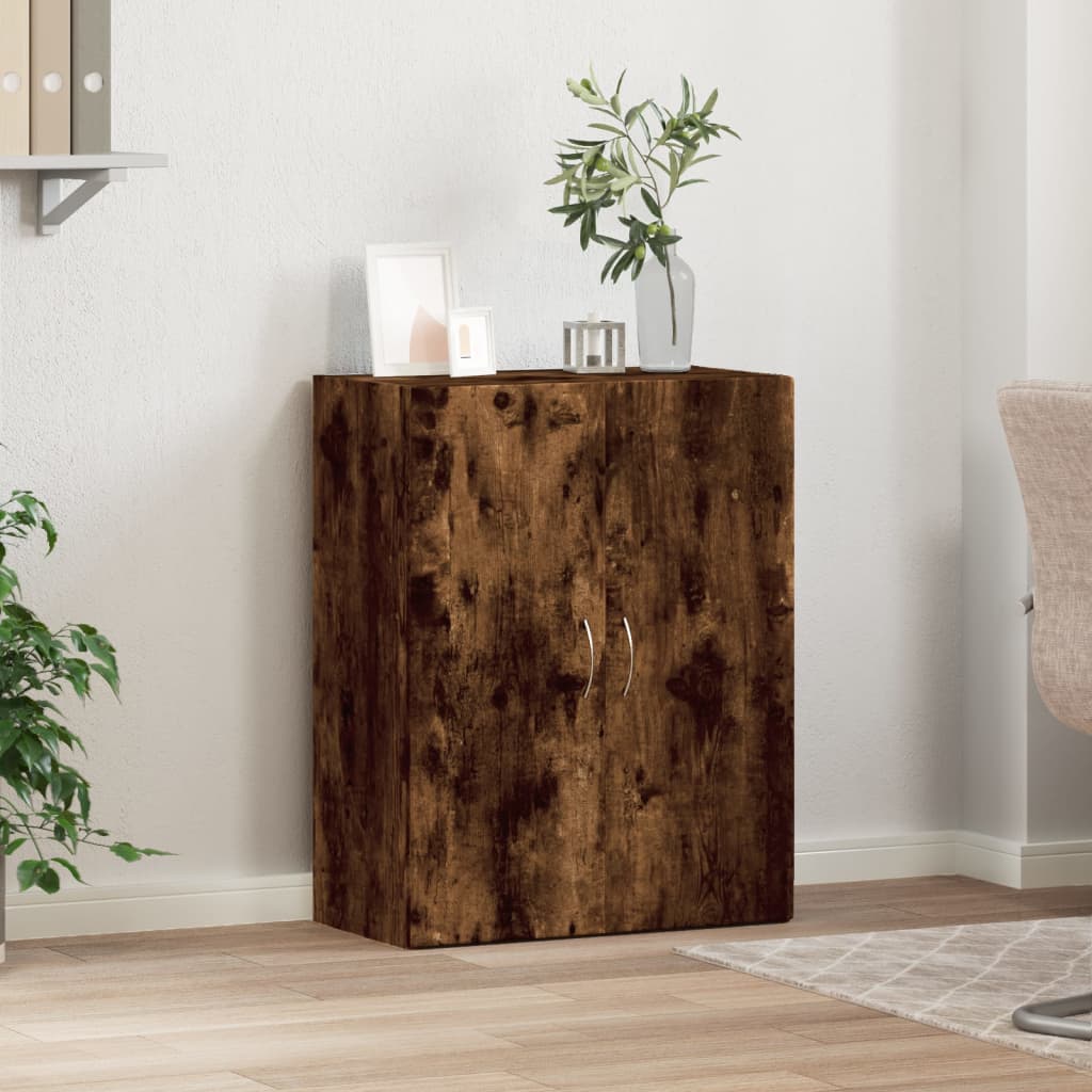 The filing cabinet placed in a bright office space with a plant and picture frames on top