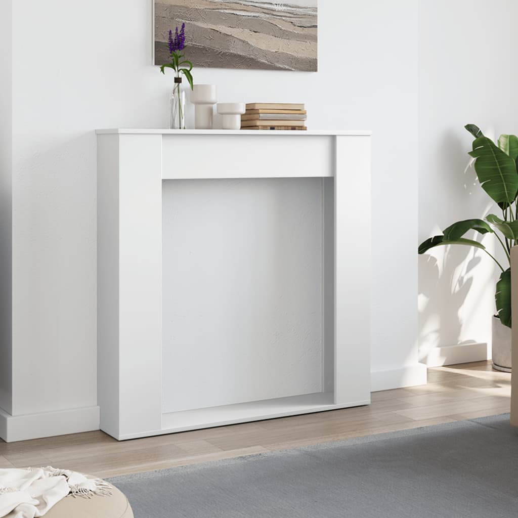 The fireplace surround placed against a white wall in a bright living room setting