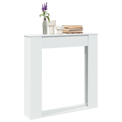 vidaXL Fireplace Surround White Engineered Wood decorated with books and a vase on the mantelpiece