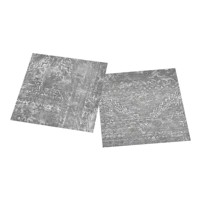 Two grey concrete effect vinyl flooring planks with a distressed pattern side by side