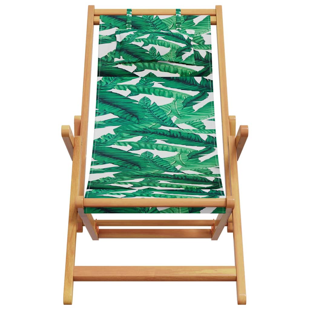 The front of the folding outdoor chair shows the wooden frame and the green leaf patterned fabric seat
