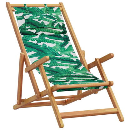 This wooden outdoor chair has a green leaf pattern fabric seat and backrest, with adjustable wooden armrests