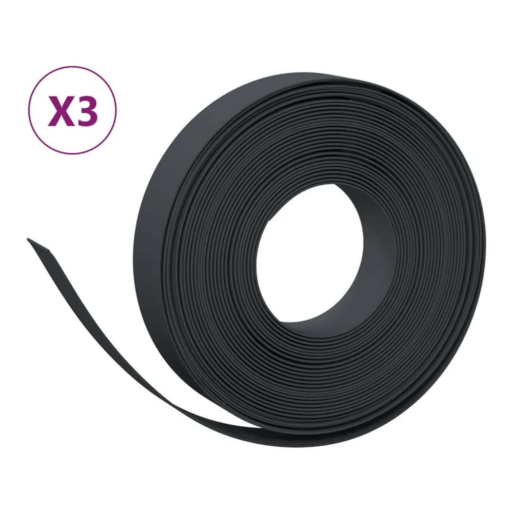 Three rolls of black garden edging, one is partially unrolled