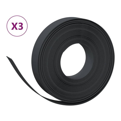 Three rolls of black garden edging, one is partially unrolled