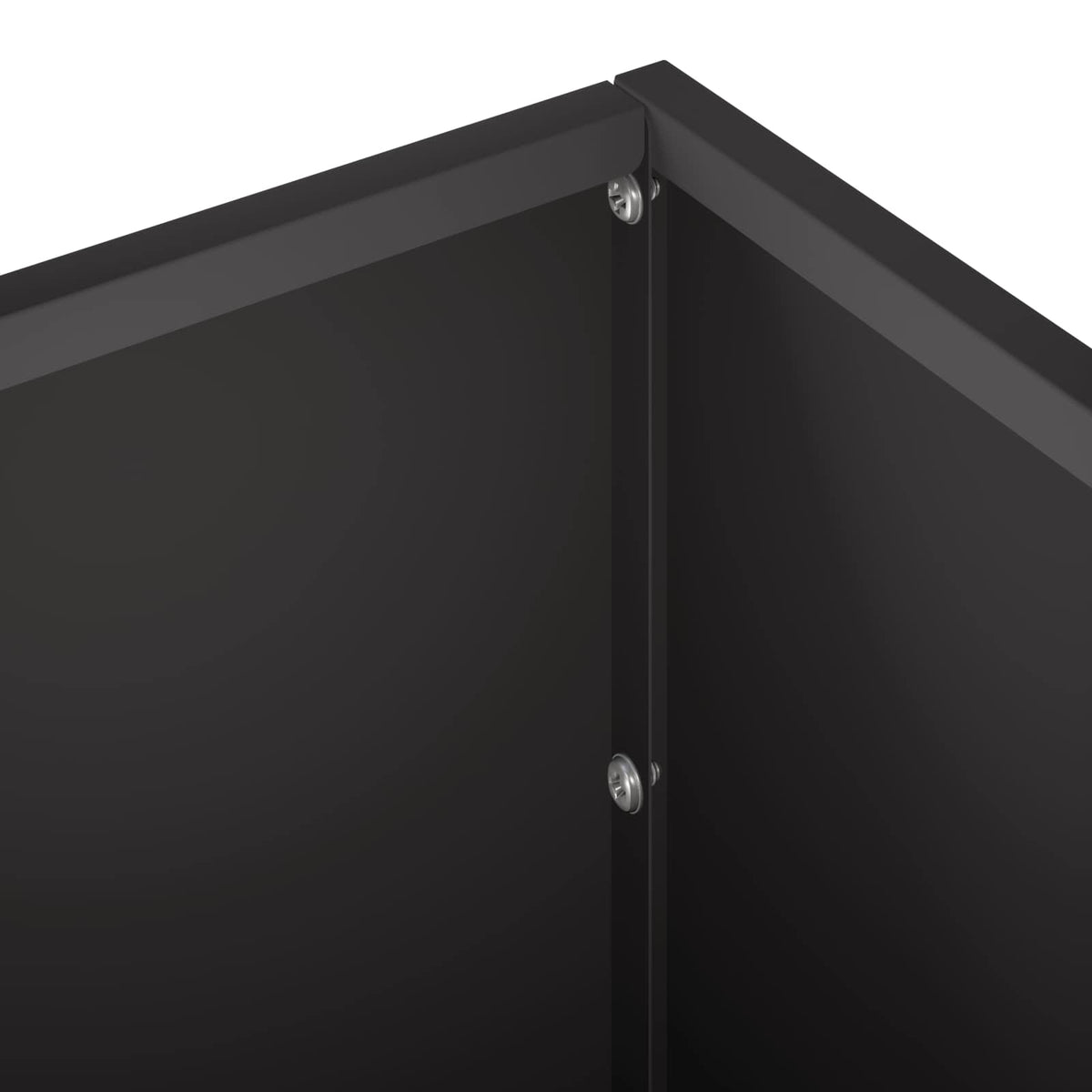 A close-up of the corner of the black garden planter showing the metal join and screws