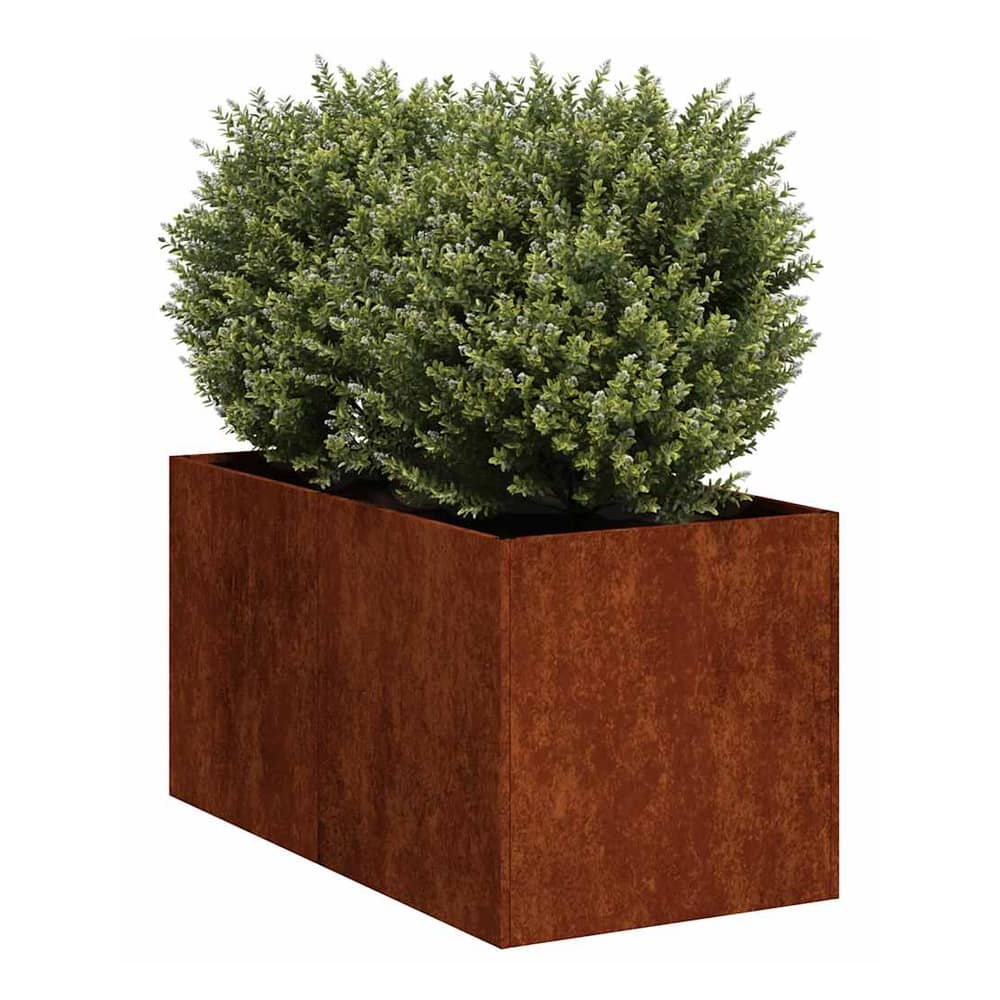 The rusty weathering steel planter with a green bush inside, shown outdoors
