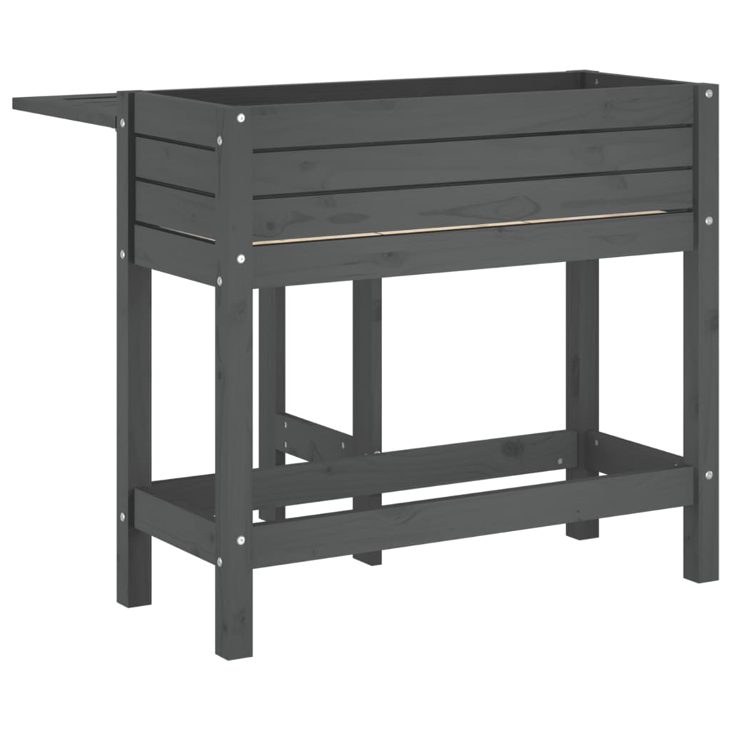 A grey wooden garden planter with a fold-out table, shown from the side with the table extended