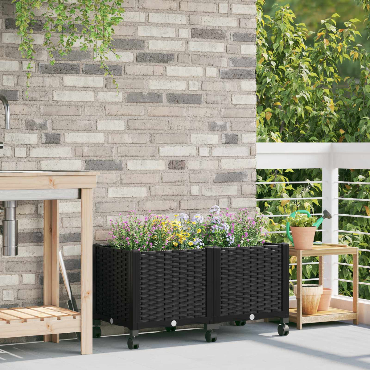 vidaXL Garden Planter with Wheels Black PP on a patio with plants