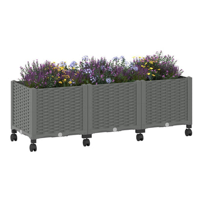 A light grey garden planter with wheels filled with purple and yellow flowers