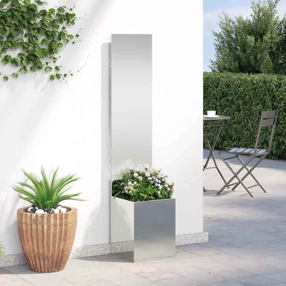 The privacy screen with planter box placed against a white wall outdoors